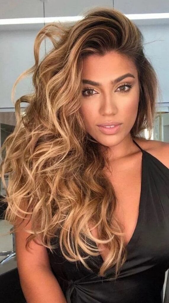 honey-balayage-on-long-wavy-hair-with-golden-highlights-and-voluminous-side-parting-7638063-7676276