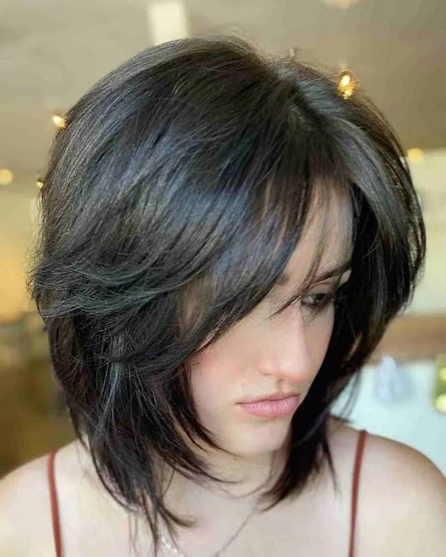 mid-length-layered-cut-on-voluminous-brown-hair-with-swept-bangs-2699700-5539021